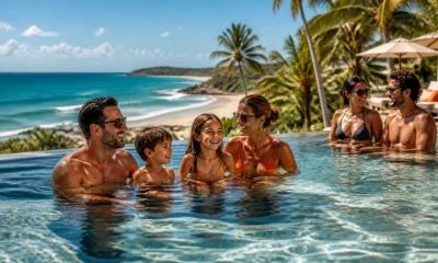 Resorts all inclusive no Nordeste: como escolher sem errar na viagem - Casal e família aproveitando área de piscina em resort all inclusive no Nordeste